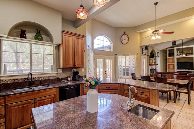 465 Hannah Dr, Dripping Springs, TX 78620 - kitchen featuring dishwasher, brown cabinets, a ceiling fan, light tile patterned floors, and open floor plan