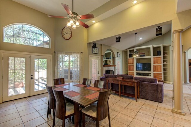 465 Hannah Dr, Dripping Springs, TX 78620 - dining room with ceiling fan, a fireplace, light tile patterned floors, high vaulted ceiling, and french doors