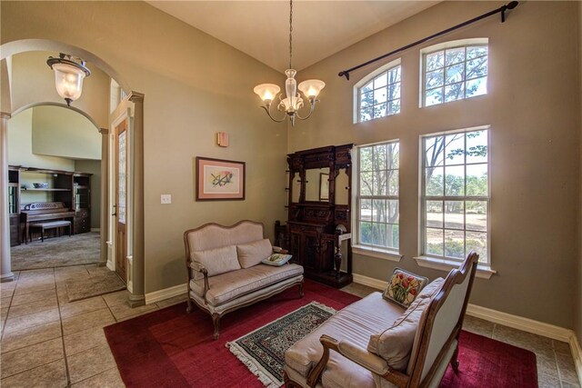 465 Hannah Dr, Dripping Springs, TX 78620 - living area with arched walkways, tile patterned flooring, a chandelier, and high vaulted ceiling