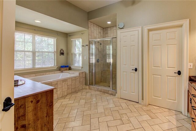 465 Hannah Dr, Dripping Springs, TX 78620 - bathroom featuring a shower stall, a garden tub, and vanity