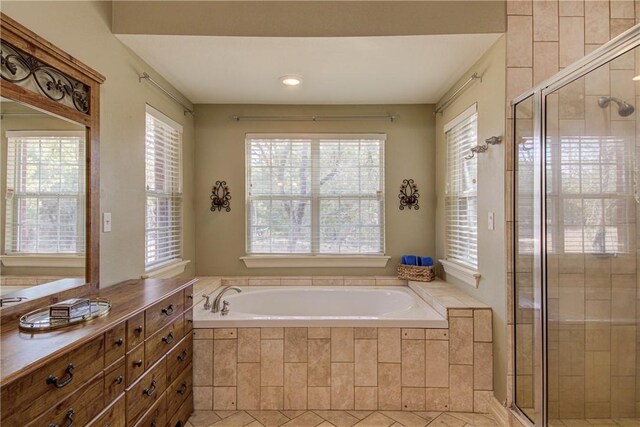 465 Hannah Dr, Dripping Springs, TX 78620 - full bath with plenty of natural light, a garden tub, a shower stall, and tile patterned flooring