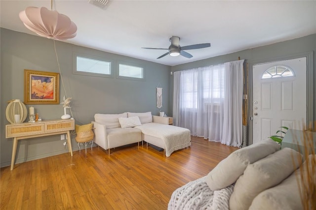 1406 Webberville Rd, Austin, TX 78721 - living room with plenty of natural light, a ceiling fan, and light wood finished floors