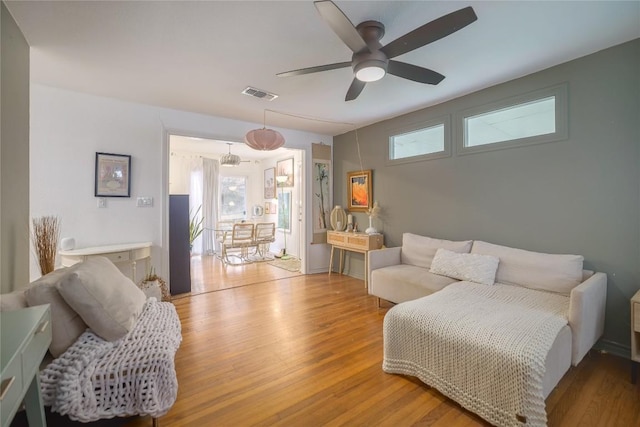 1406 Webberville Rd, Austin, TX 78721 - bedroom featuring wood finished floors, multiple windows, and a ceiling fan