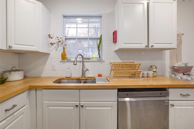 1406 Webberville Rd, Austin, TX 78721 - kitchen featuring dishwasher, butcher block counters, tasteful backsplash, and white cabinets