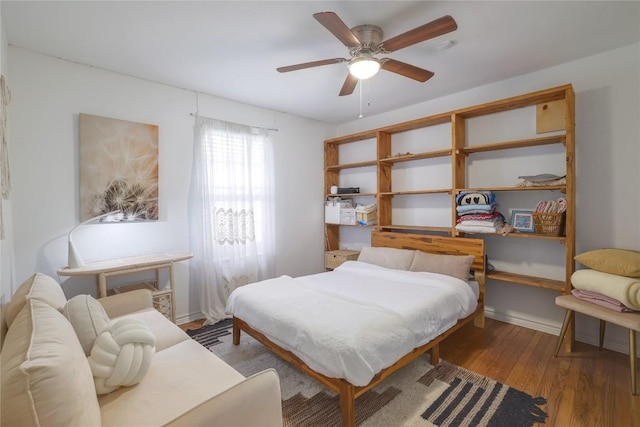 1406 Webberville Rd, Austin, TX 78721 - bedroom featuring wood finished floors and a ceiling fan