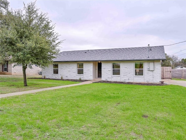 ranch-style home featuring a front yard