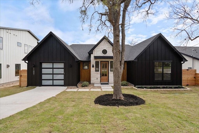 modern inspired farmhouse with a garage and a front yard