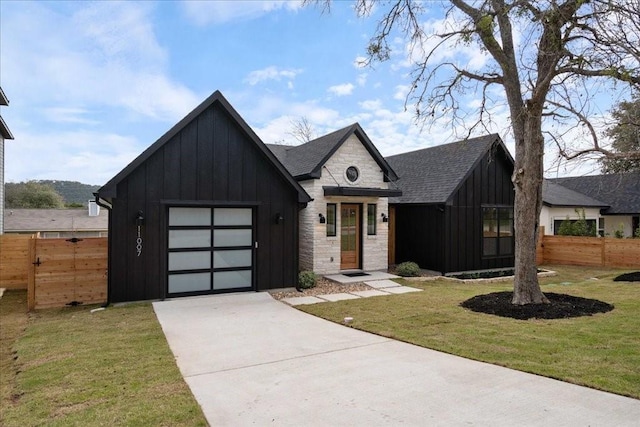 view of front of home with a garage and a front lawn