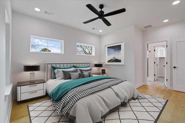 bedroom with ceiling fan and light wood-type flooring