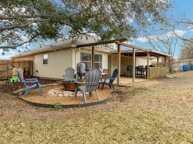 back of property featuring an outdoor fire pit and a patio