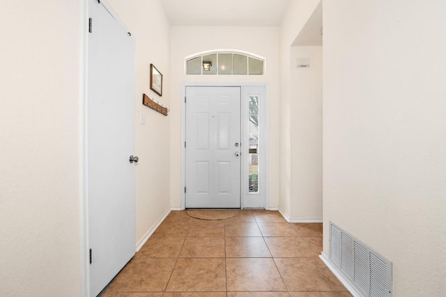 foyer entrance with light tile patterned floors