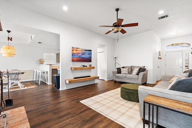 living room with ceiling fan and dark hardwood / wood-style flooring