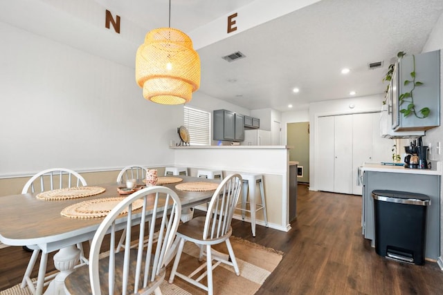 dining space with dark hardwood / wood-style floors