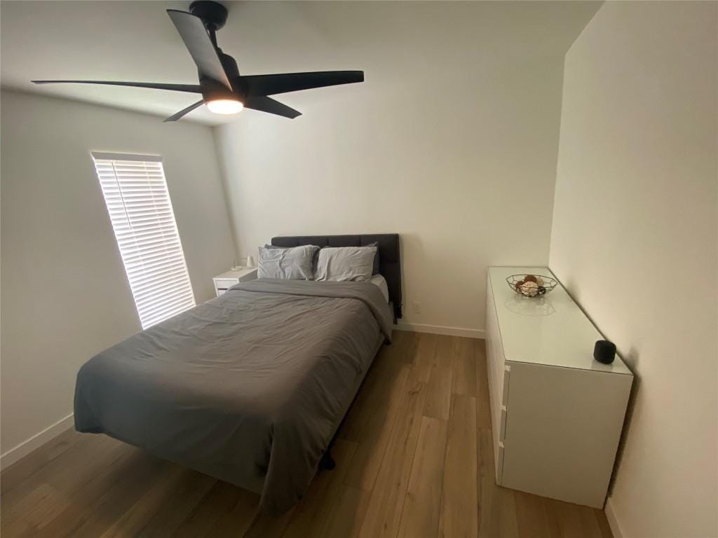 bedroom featuring light wood-type flooring and ceiling fan