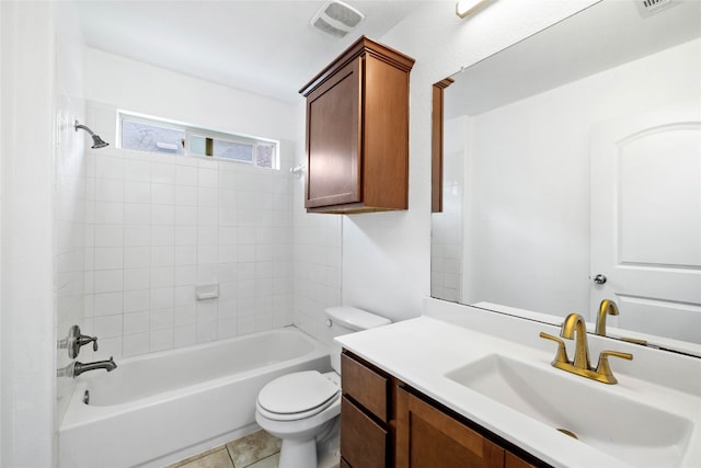 full bathroom featuring tile patterned flooring, tiled shower / bath, vanity, and toilet