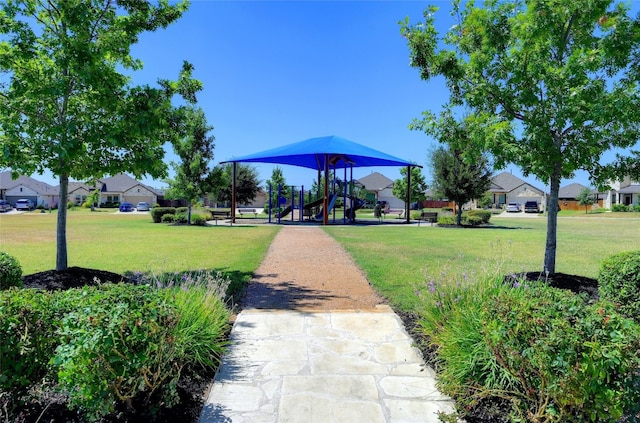 view of home's community with a yard and a playground