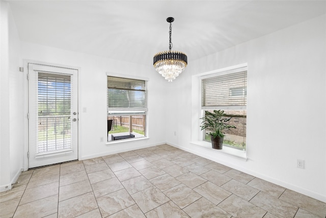 interior space with a notable chandelier and light tile patterned flooring