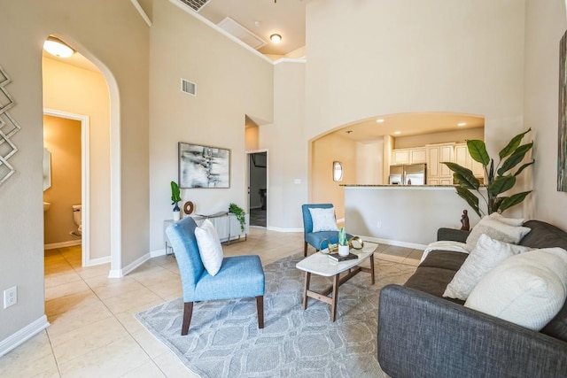 tiled living room with a high ceiling