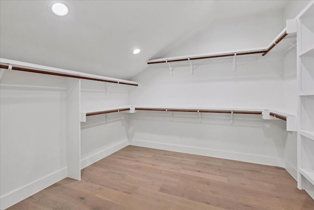 spacious closet with lofted ceiling and light wood-type flooring