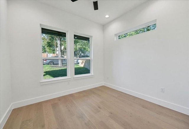 empty room featuring ceiling fan and light hardwood / wood-style floors