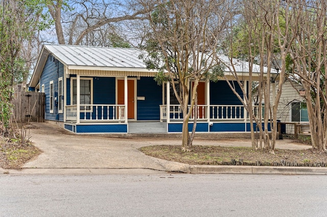 view of front of house with covered porch, metal roof, and a standing seam roof