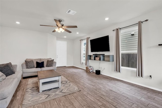 living room with ceiling fan and hardwood / wood-style floors