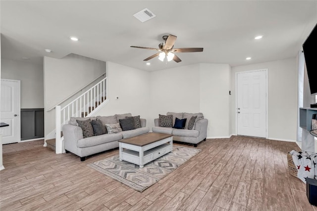 living room with ceiling fan and light wood-type flooring