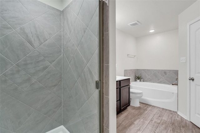 full bathroom with toilet, vanity, shower with separate bathtub, and wood-type flooring