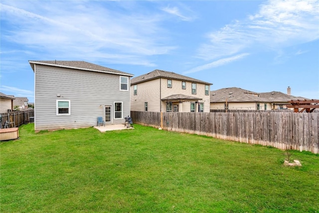 back of house with a patio and a lawn