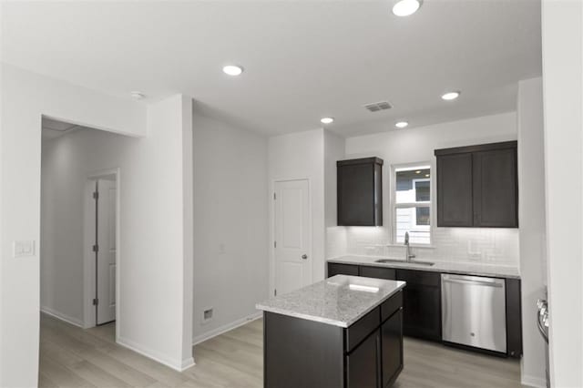 168 Bosque Dr, San Marcos, TX 78666 - kitchen featuring stainless steel dishwasher, a sink, light wood finished floors, tasteful backsplash, and recessed lighting