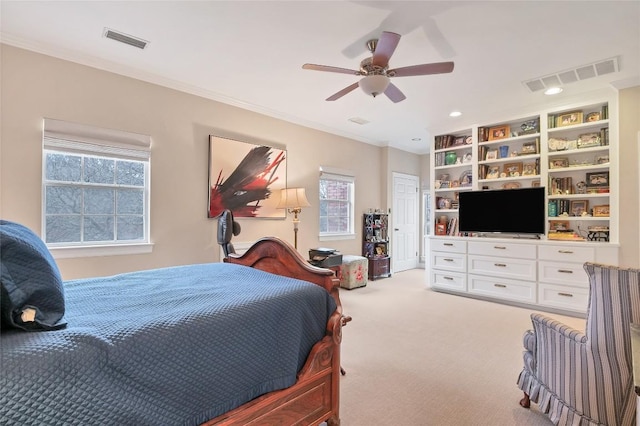 bedroom featuring ceiling fan, crown molding, and carpet floors