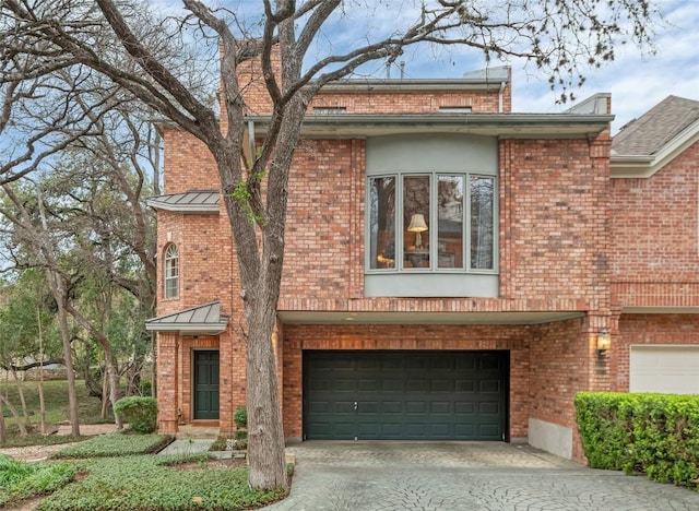 2716 Hillview Green Ln, Austin, TX 78703 - traditional-style home featuring an attached garage, a standing seam roof, driveway, and brick siding