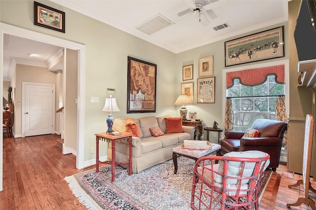 sitting room featuring ceiling fan, wood-type flooring, and ornamental molding