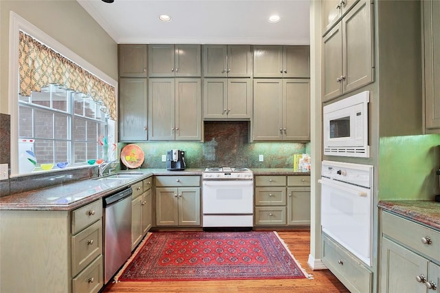 kitchen featuring gray cabinets, white appliances, backsplash, and light wood-type flooring