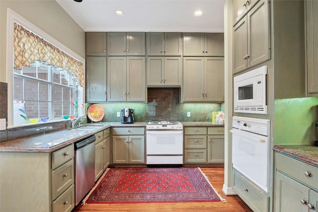 2716 Hillview Green Ln, Austin, TX 78703 - kitchen featuring white appliances, wood finished floors, backsplash, stone countertops, and recessed lighting