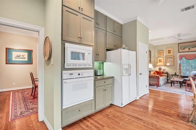 kitchen with green cabinetry, white appliances, light wood-type flooring, and ceiling fan