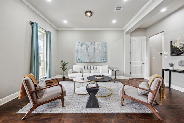 sitting room with ornamental molding and dark hardwood / wood-style floors