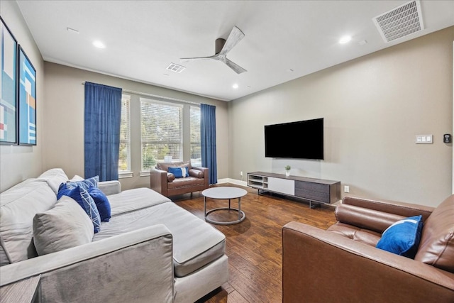 living room with ceiling fan and dark hardwood / wood-style flooring