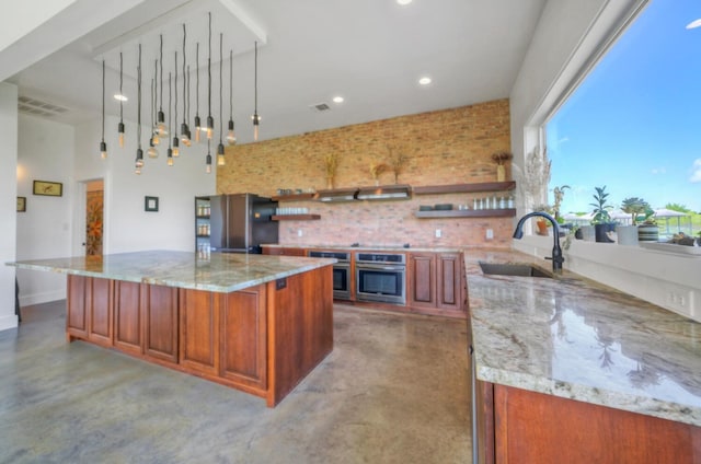 kitchen featuring stainless steel appliances, decorative light fixtures, concrete flooring, sink, and light stone counters