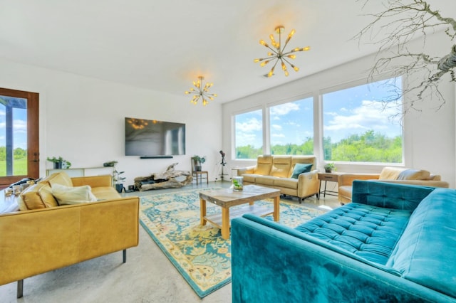 living room featuring a wealth of natural light and a notable chandelier