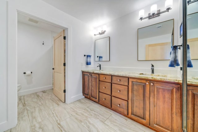 bathroom with vanity and toilet