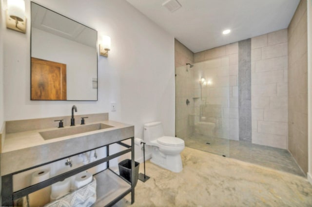 bathroom featuring tiled shower, sink, and toilet