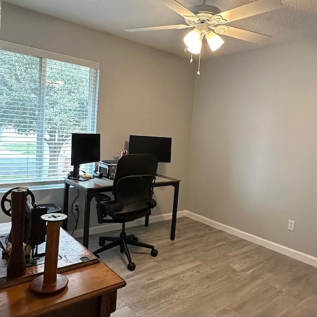 office area with ceiling fan, a textured ceiling, and hardwood / wood-style floors