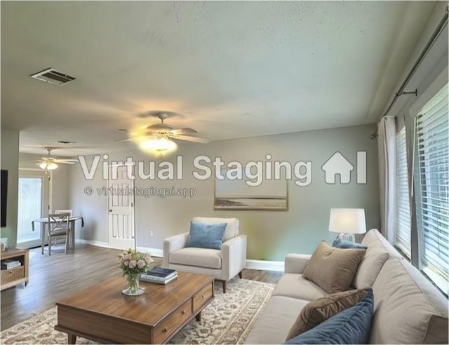 living room featuring ceiling fan, hardwood / wood-style flooring, and a wealth of natural light