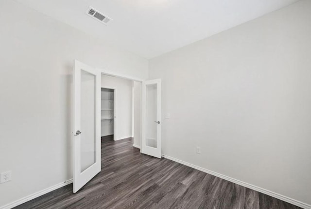 spare room featuring dark hardwood / wood-style flooring