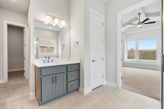 bathroom with ceiling fan, a healthy amount of sunlight, and baseboards