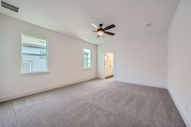 unfurnished room with a ceiling fan, carpet, visible vents, and baseboards