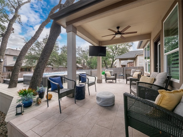 view of patio with an outdoor living space and ceiling fan