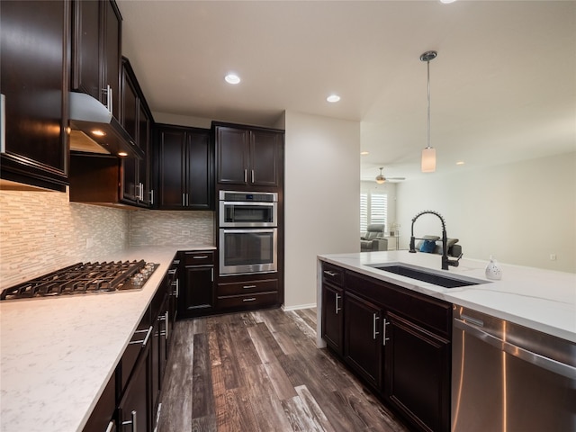 1432 Uhland Dr, Leander, TX 78641 - kitchen featuring stainless steel appliances, a sink, exhaust hood, tasteful backsplash, and decorative light fixtures