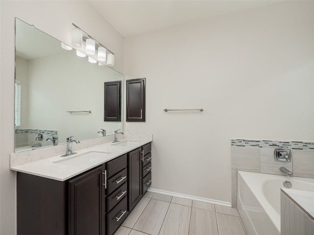 1432 Uhland Dr, Leander, TX 78641 - full bath featuring double vanity, a garden tub, baseboards, and tile patterned floors